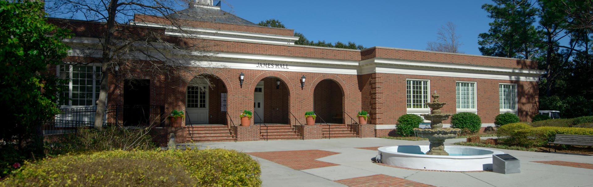Entrance to James Hall building with fountain in front