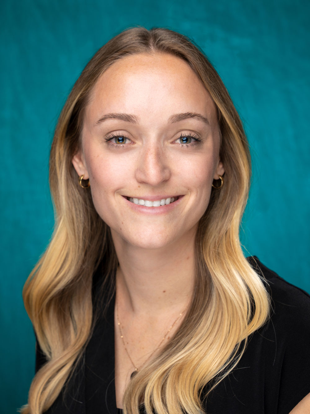 Portrait of Casey Shotton with Teal Background