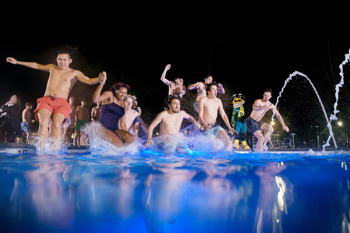 People jumping in to the outdoor pool