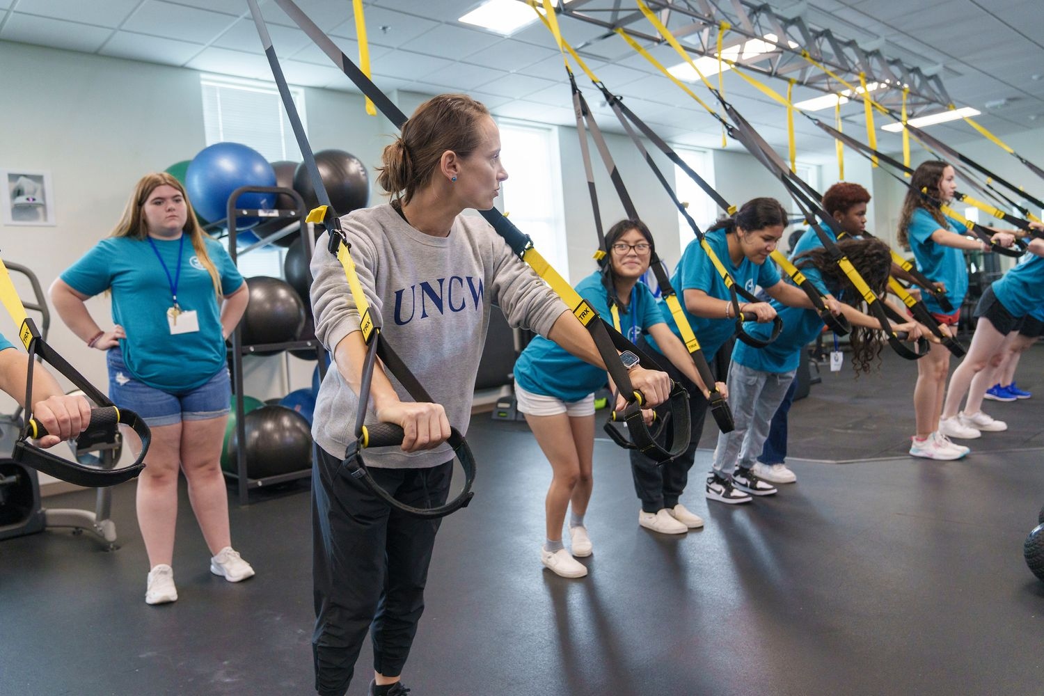 Students and trainer in gym