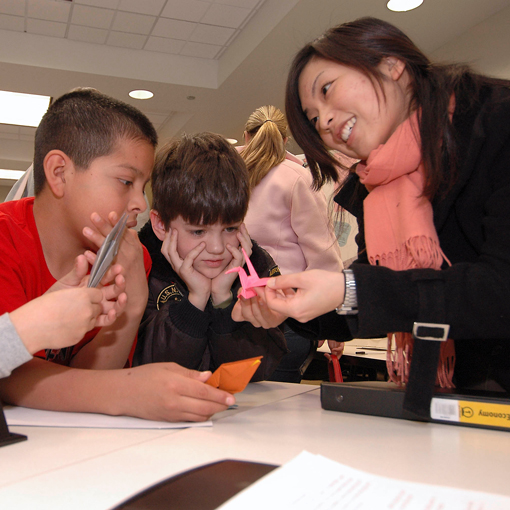 Teacher shows paper crane to students