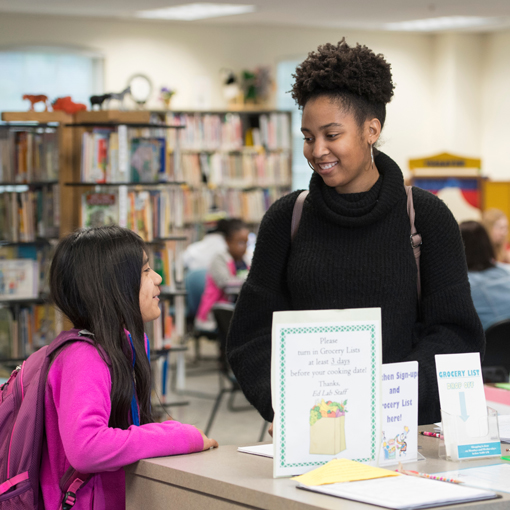 Students stand in library