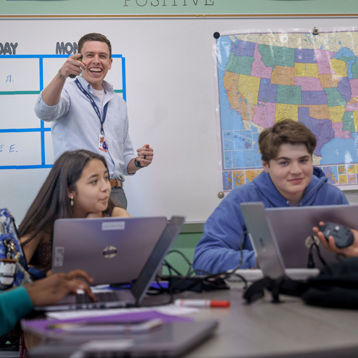 Teacher smiles while calling on student