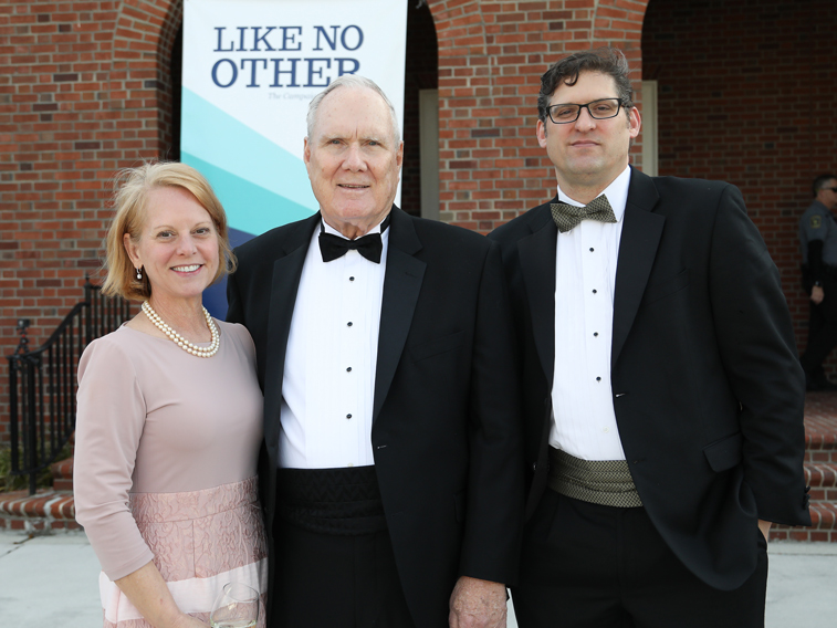 Three Gala attendees smile for camera