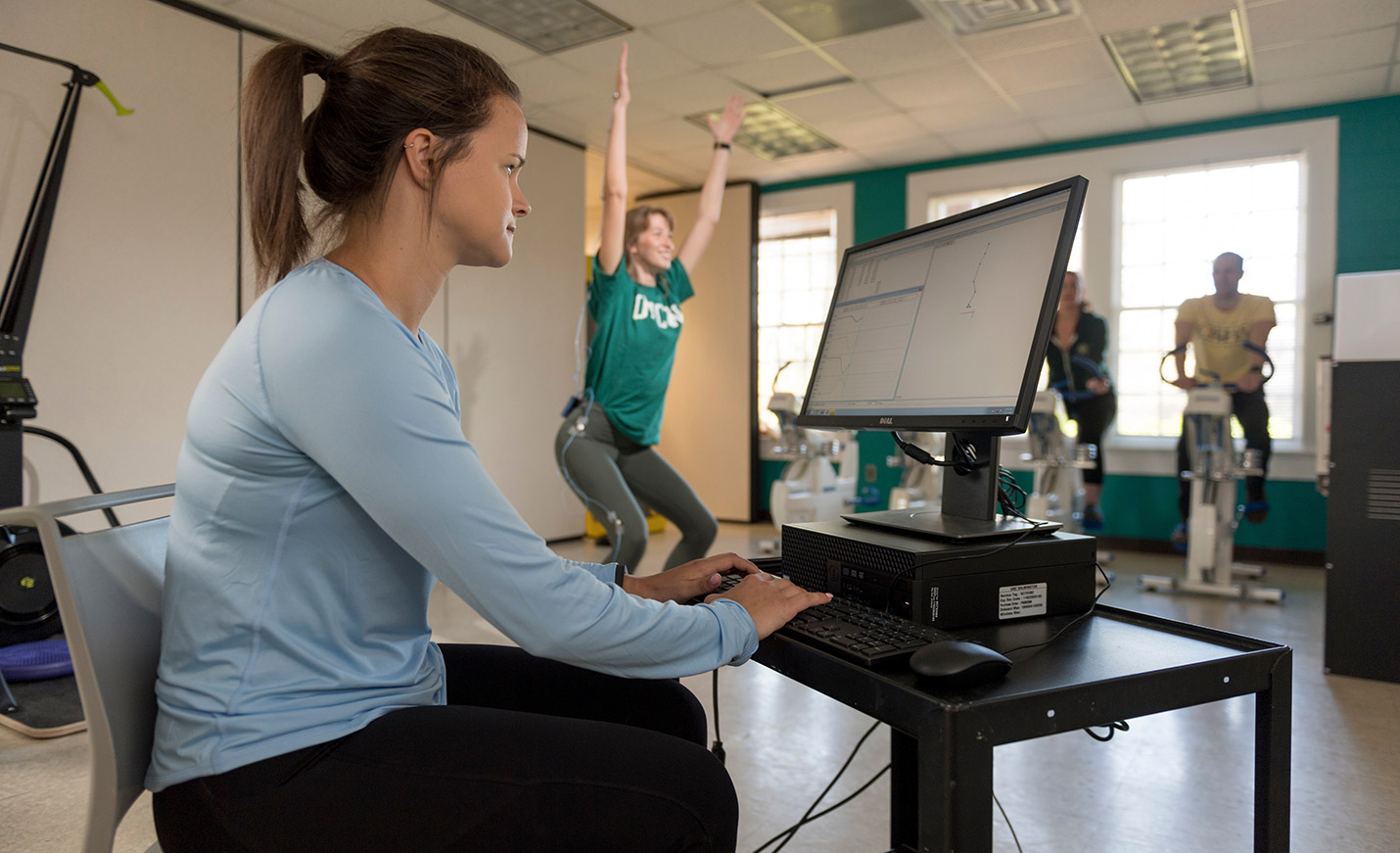 A student analyzing data from another student who's exercising.