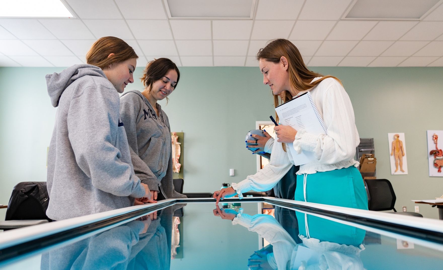 People working over an anatomy table