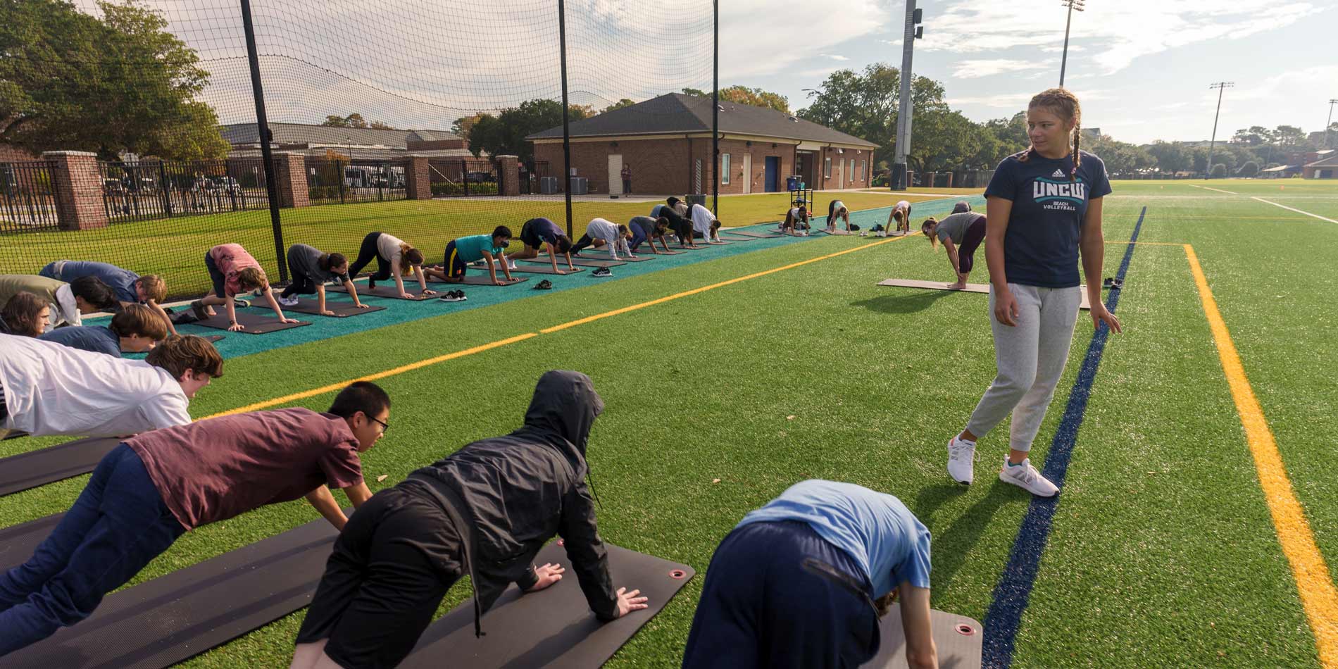 A group of people stretching during an outdoor fitness class