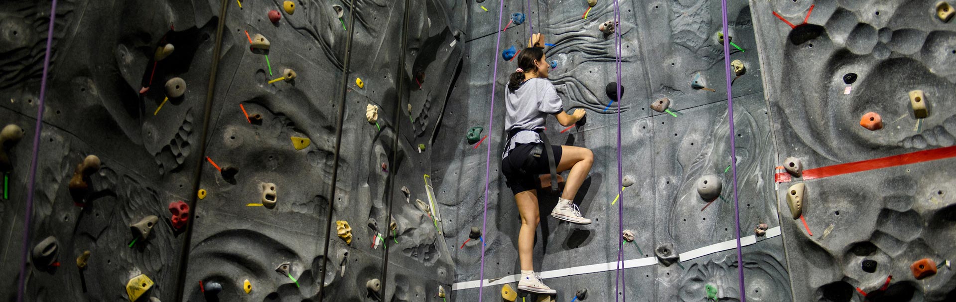 Person rockclimbing an indoor rock wall