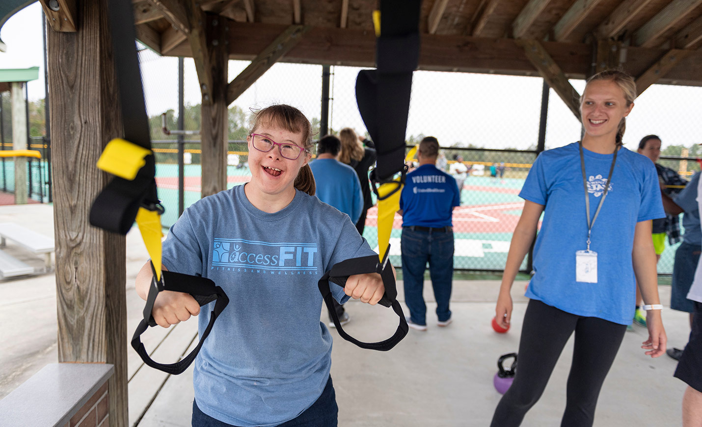 access fit participants visit campus to practice exercising independently on trx cables while recreation therapy students watch and assist as needed.  