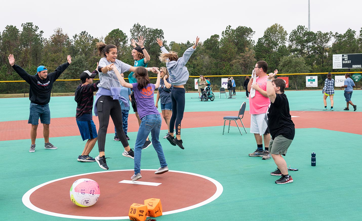 A group of students jump in the air together outside.