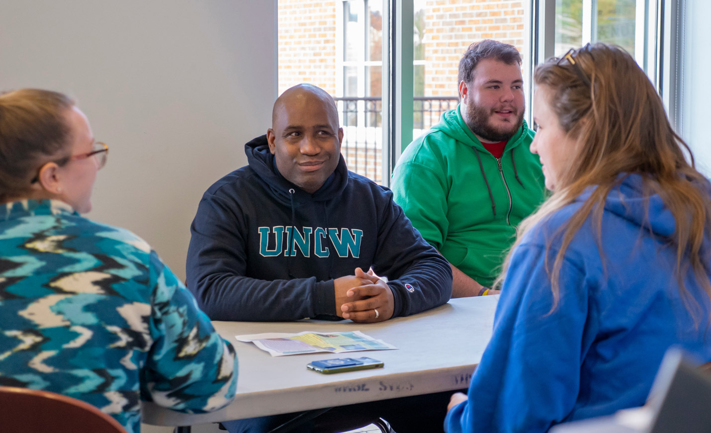 People talking while seated at a table