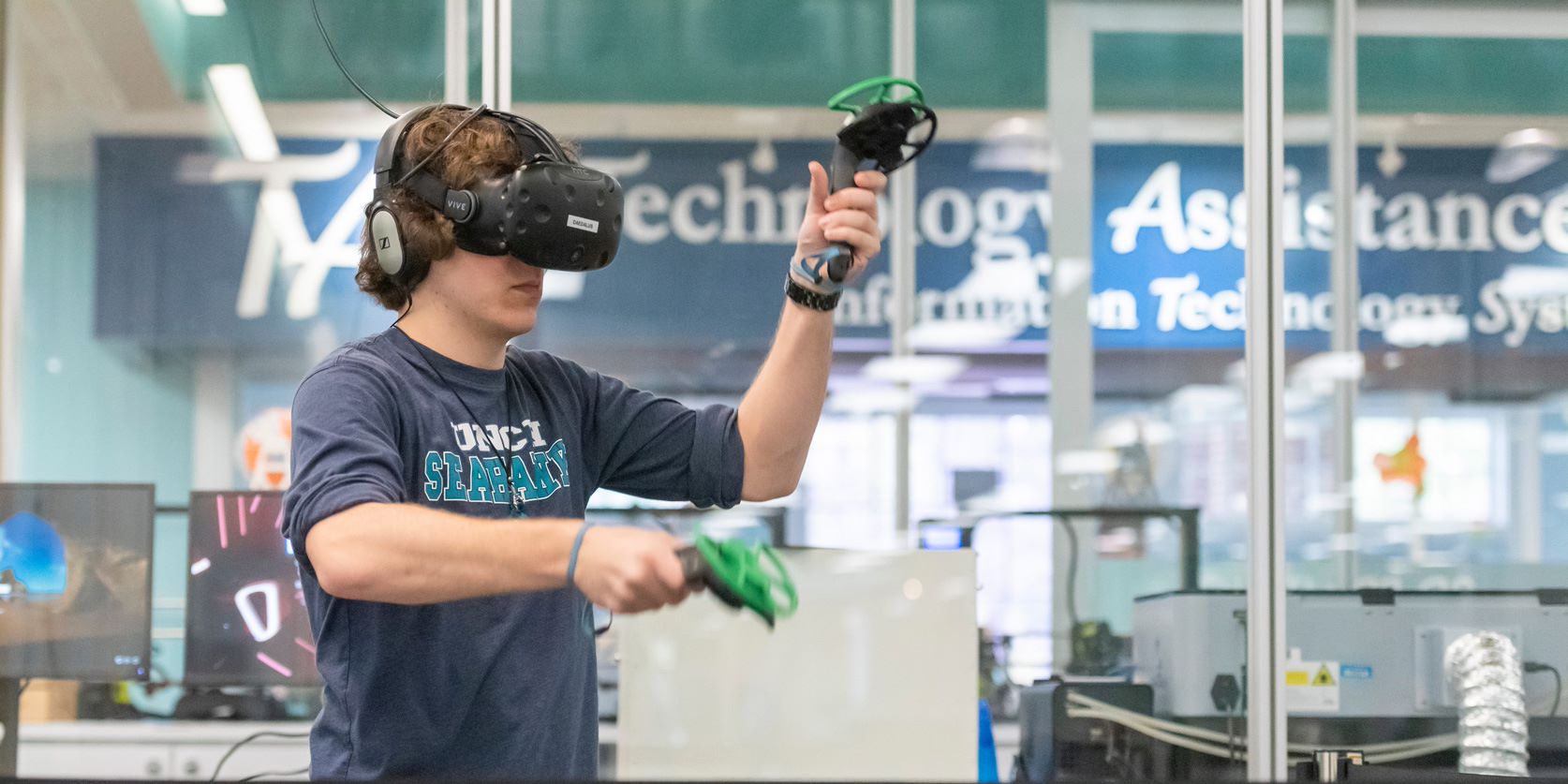 A student takes part in a game on a virtual reality headset 
