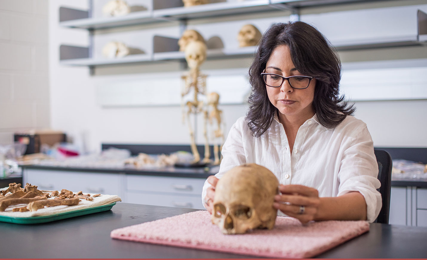 Woman touching skull