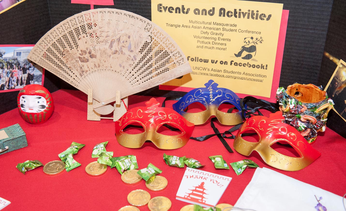 display of Asian items - fan, masks, candy, coins