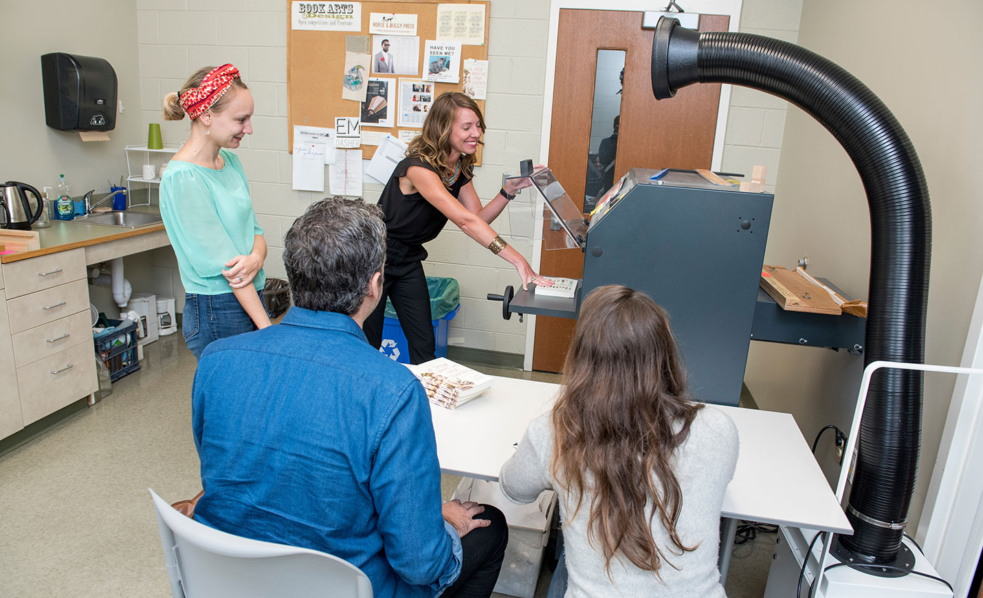 students using equipment in publishing laboratory