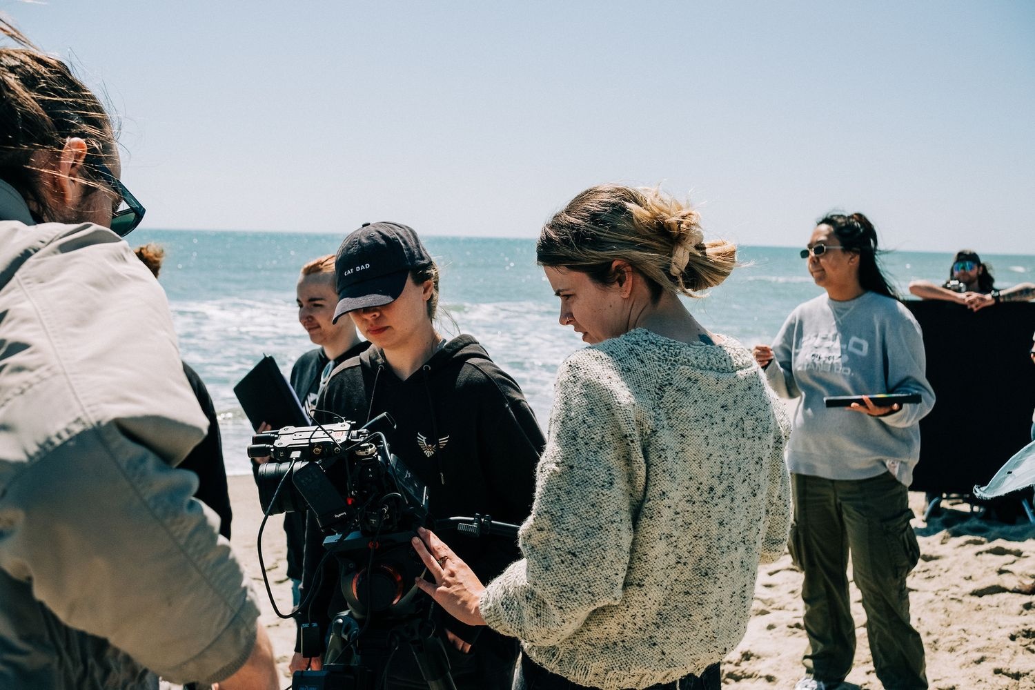 Students filming on the beach