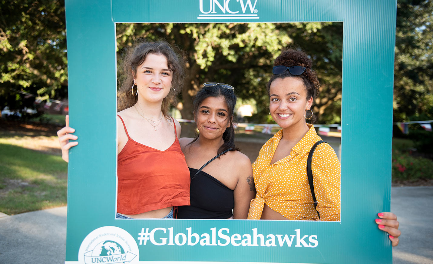 Students standing in a #GlobalSeahawks frame