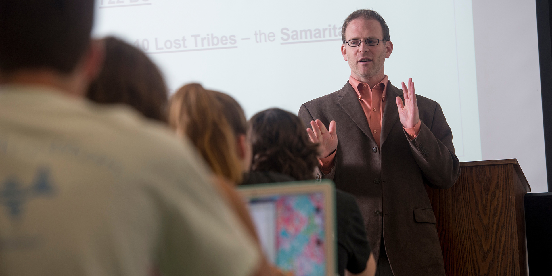 A history professor gives a lecture to a class