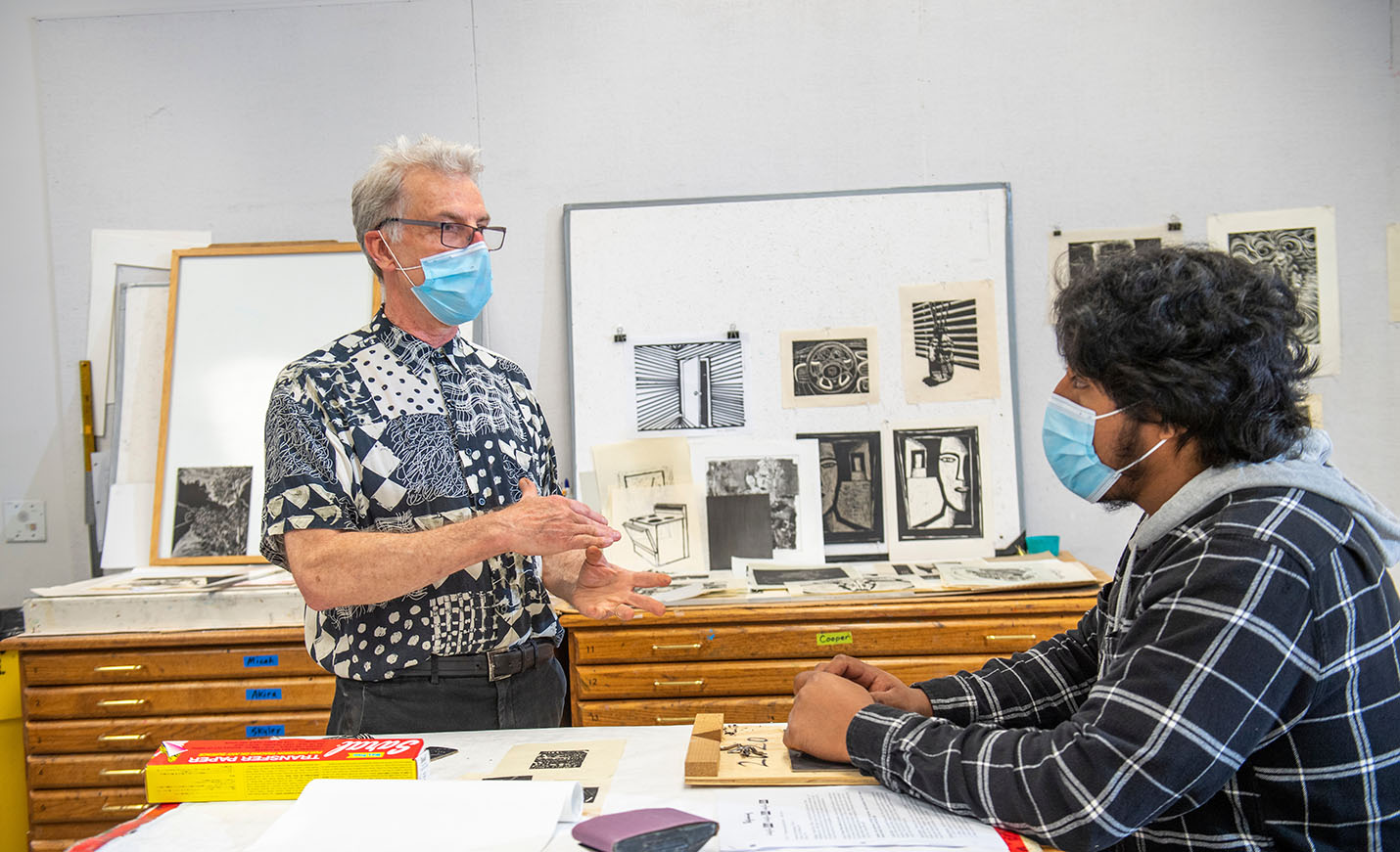 faculty members and student discuss art