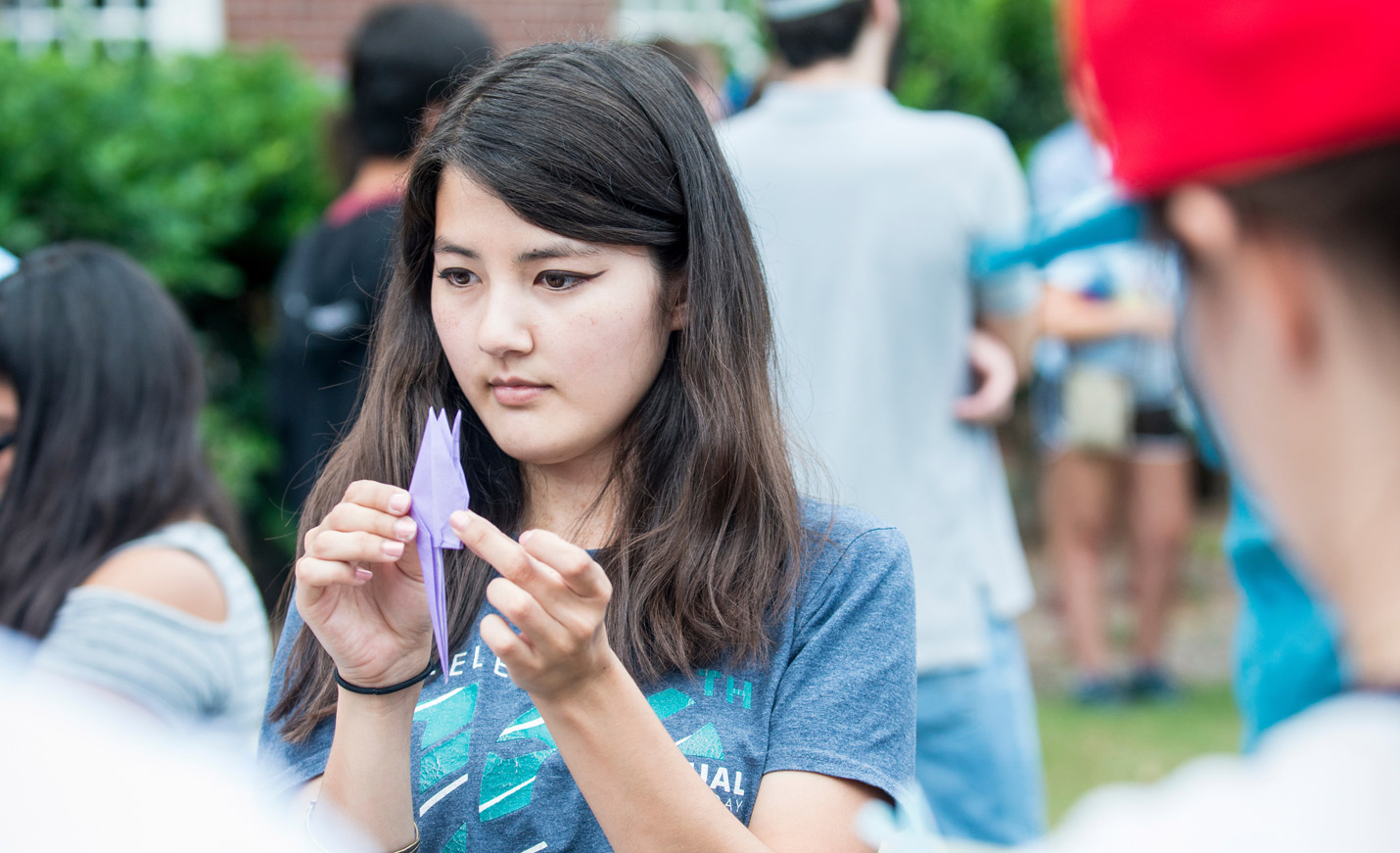 student shows off her origami
