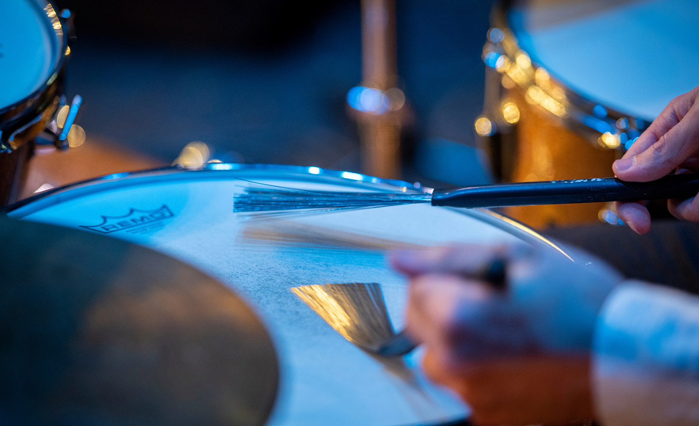 student plays drums with brushes