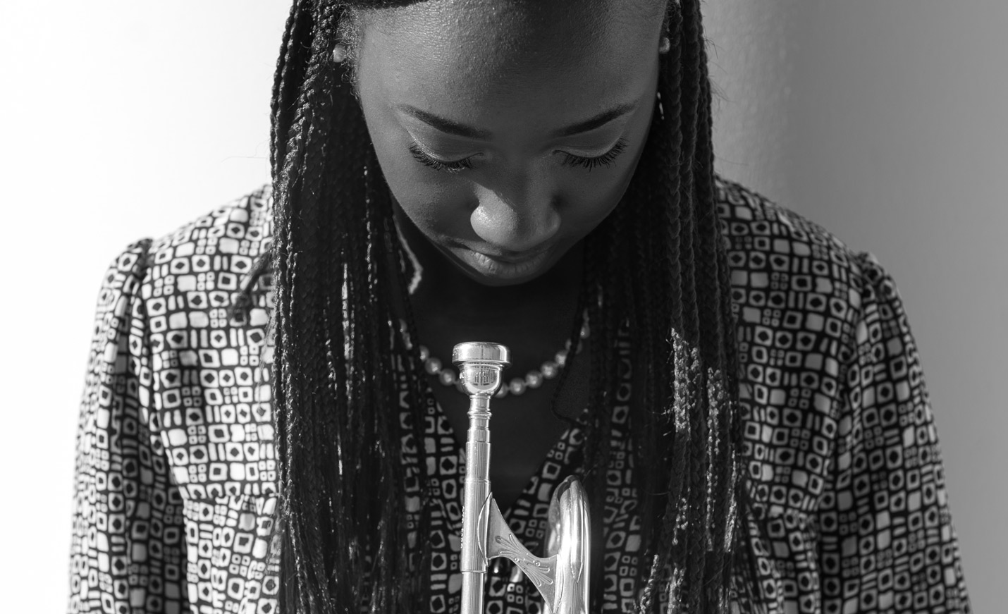 student looking down at a trumpet