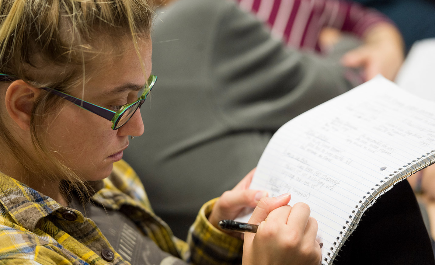student writing in a notebook