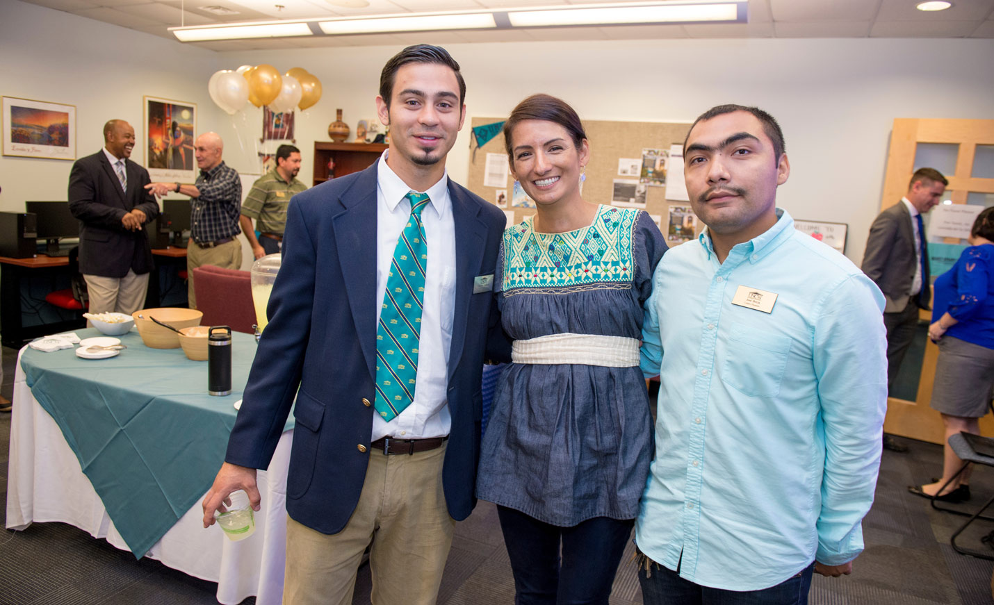 Centro Hispano staff pose for a photo during a reception at the center
