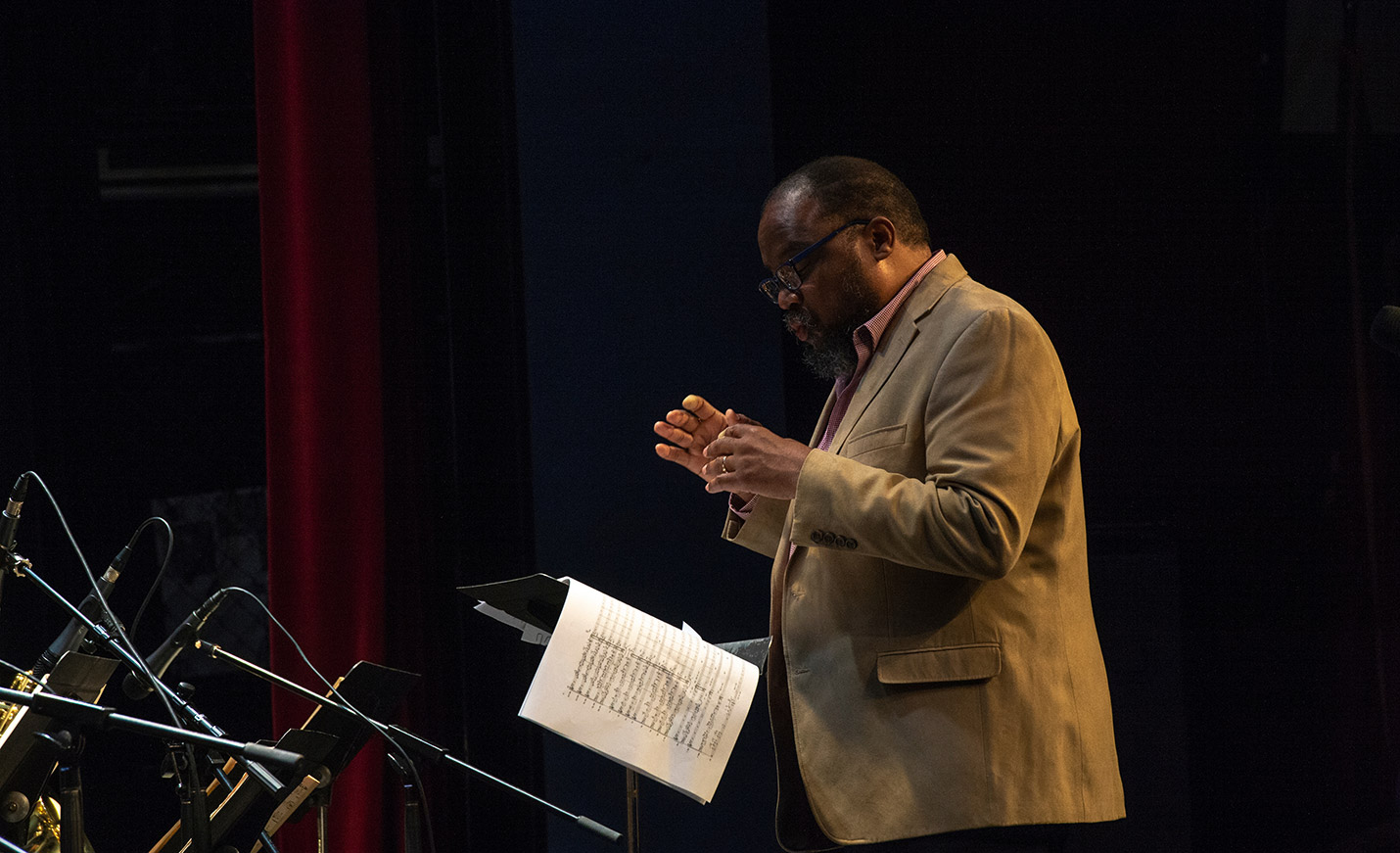 A composer orchestrating a piece during a performance
