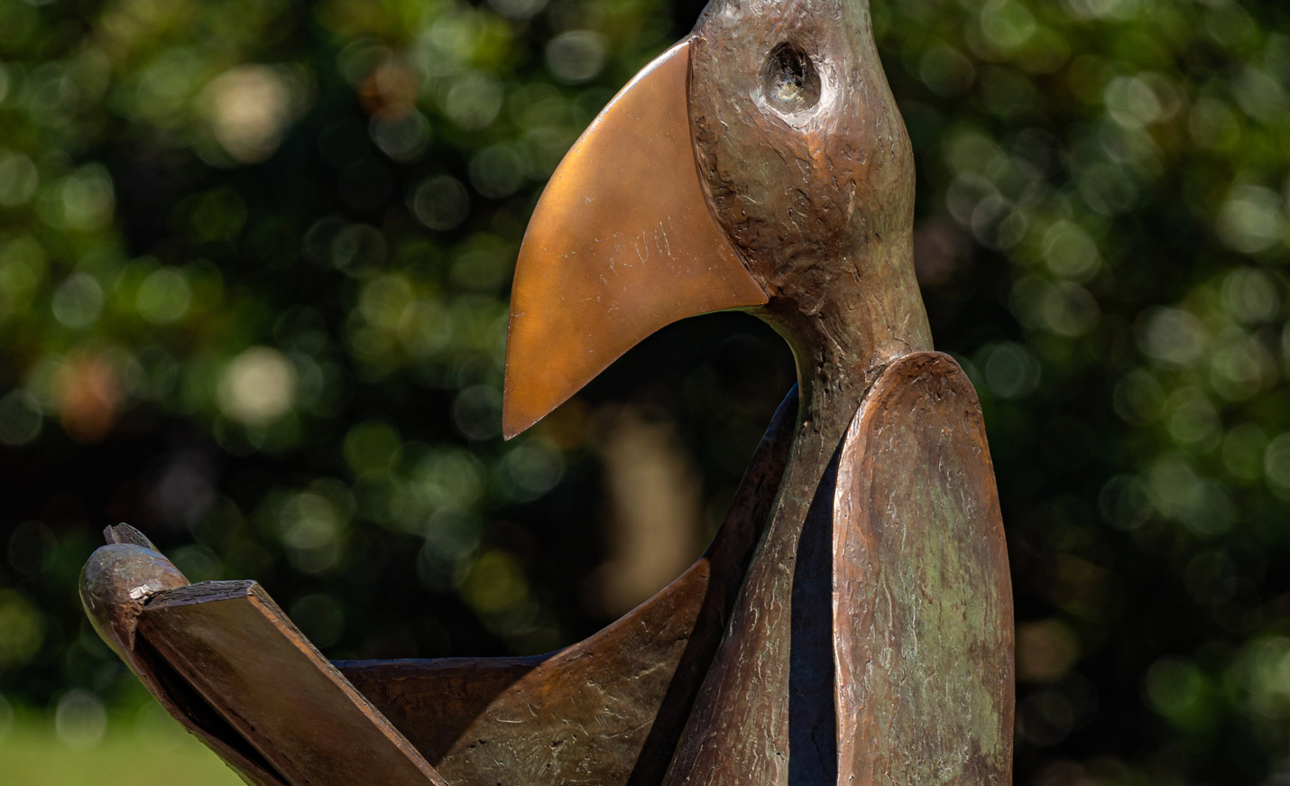 A close-up of the reading bird sculpture that sits outside UNCW Library