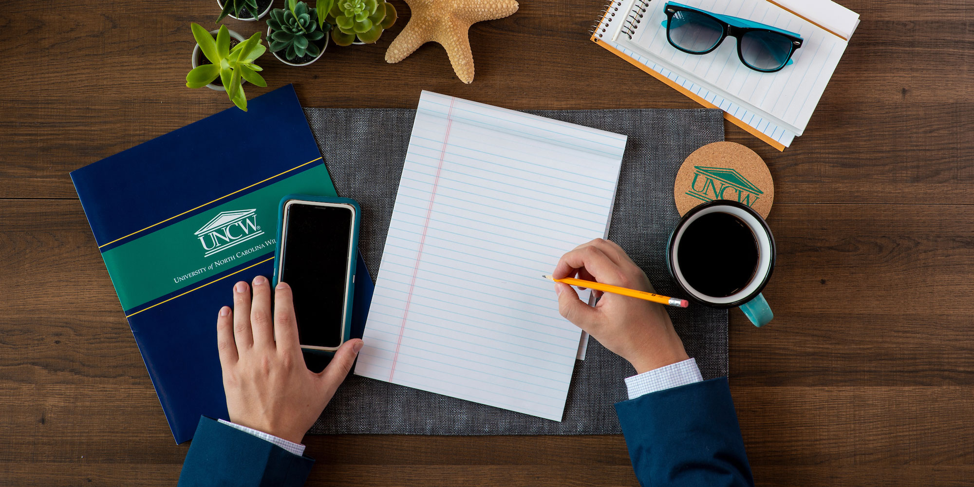 A person writing at a desk