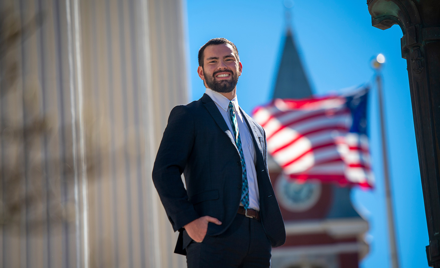 An American flag behind a student