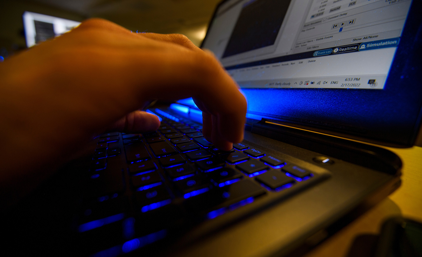 Close-up of fingers typing on a computer keyboard