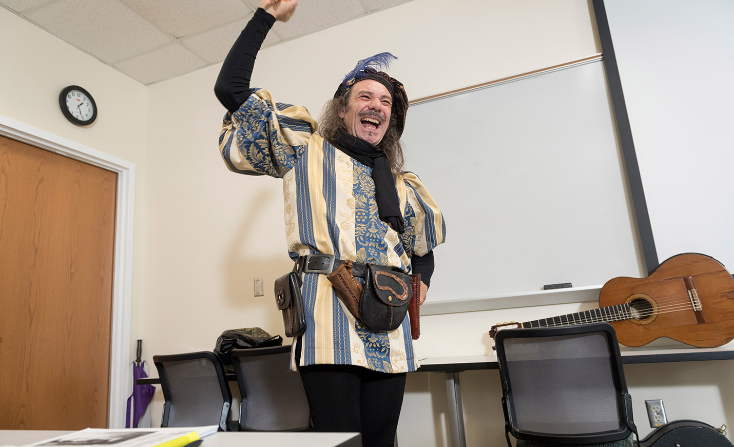 An animated actor dressed as Don Quixote at the front of a classroom