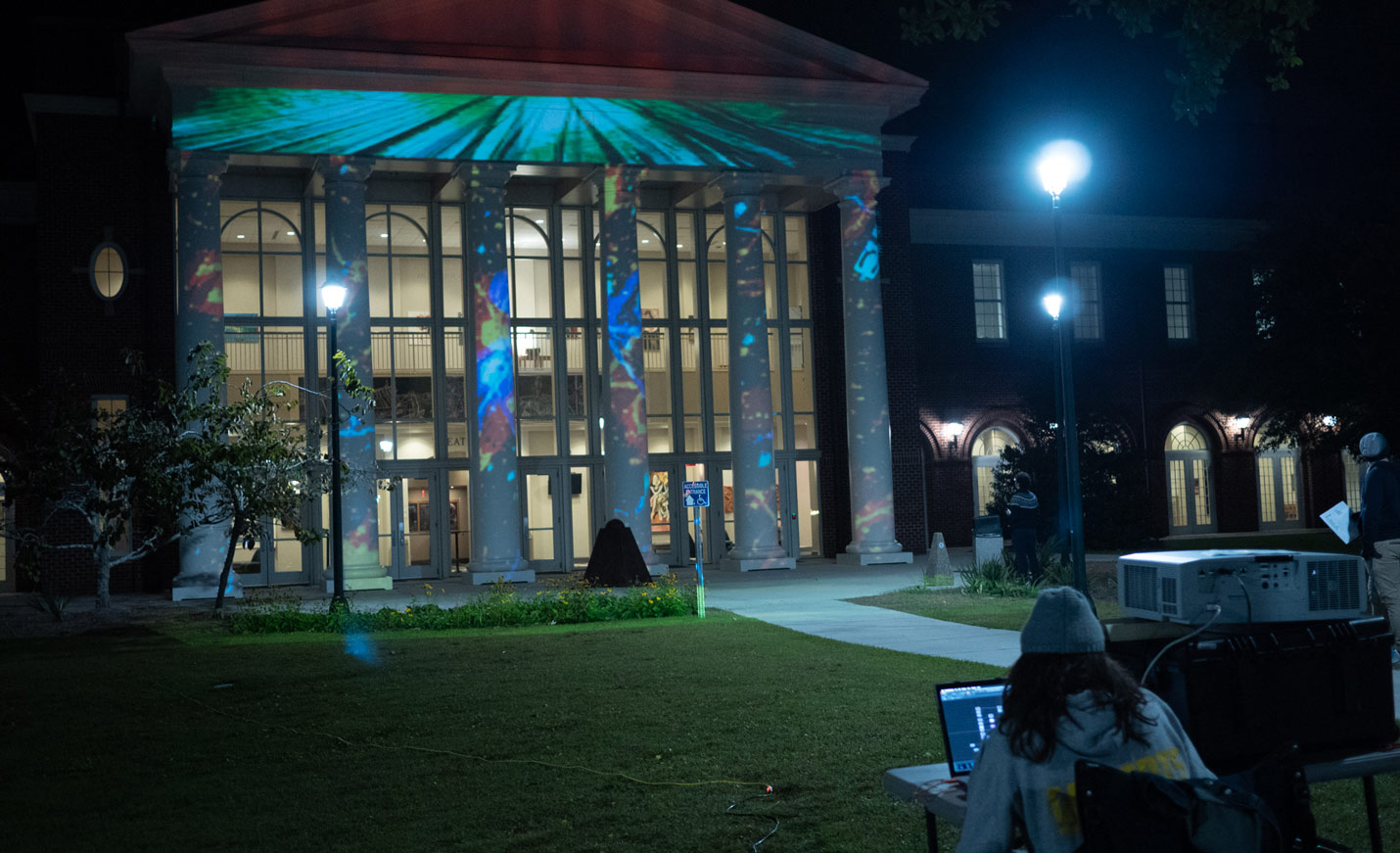 Art design projected onto the exterior of the Cultural Arts Building at night