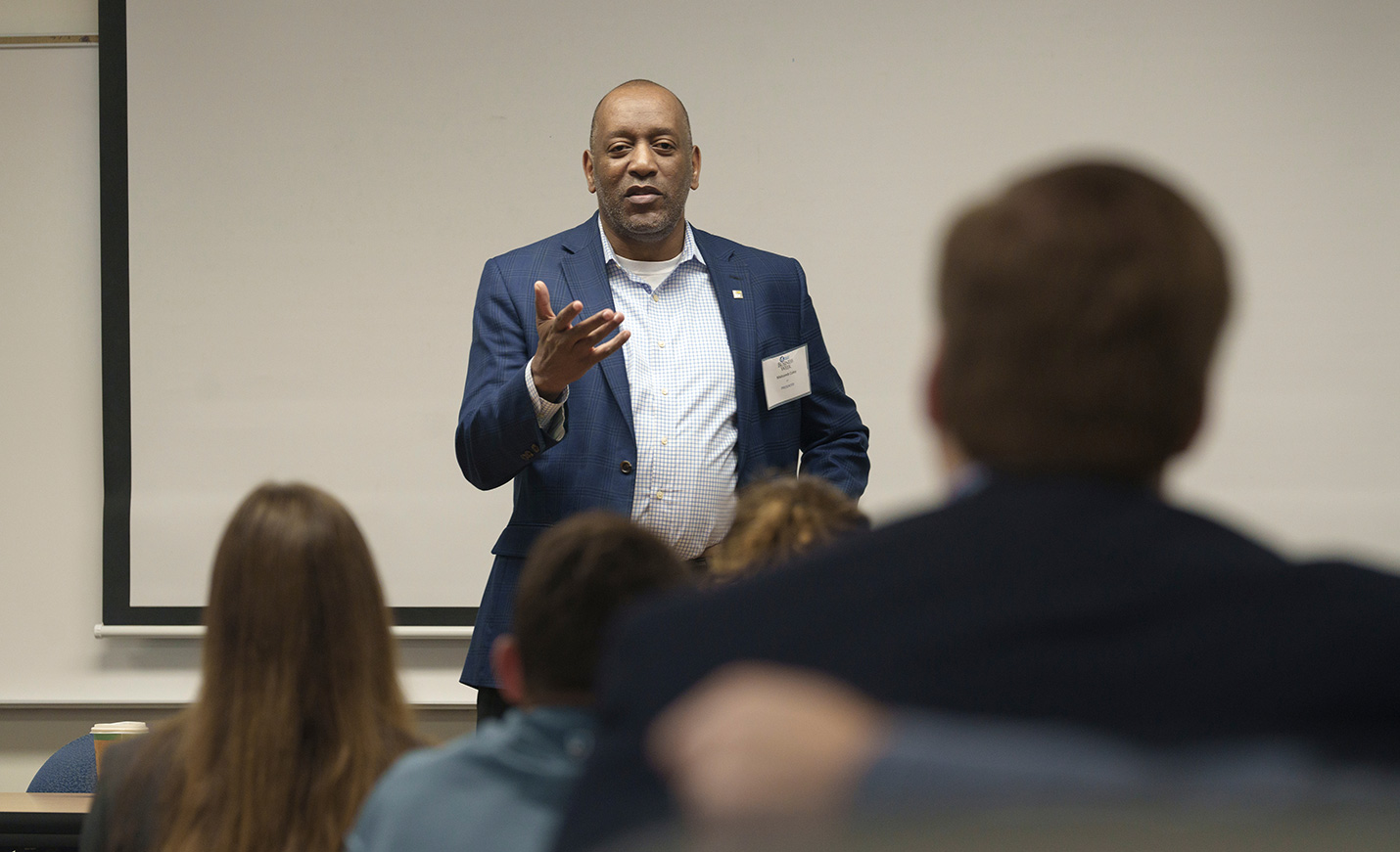 speaker wearing suit in classroom