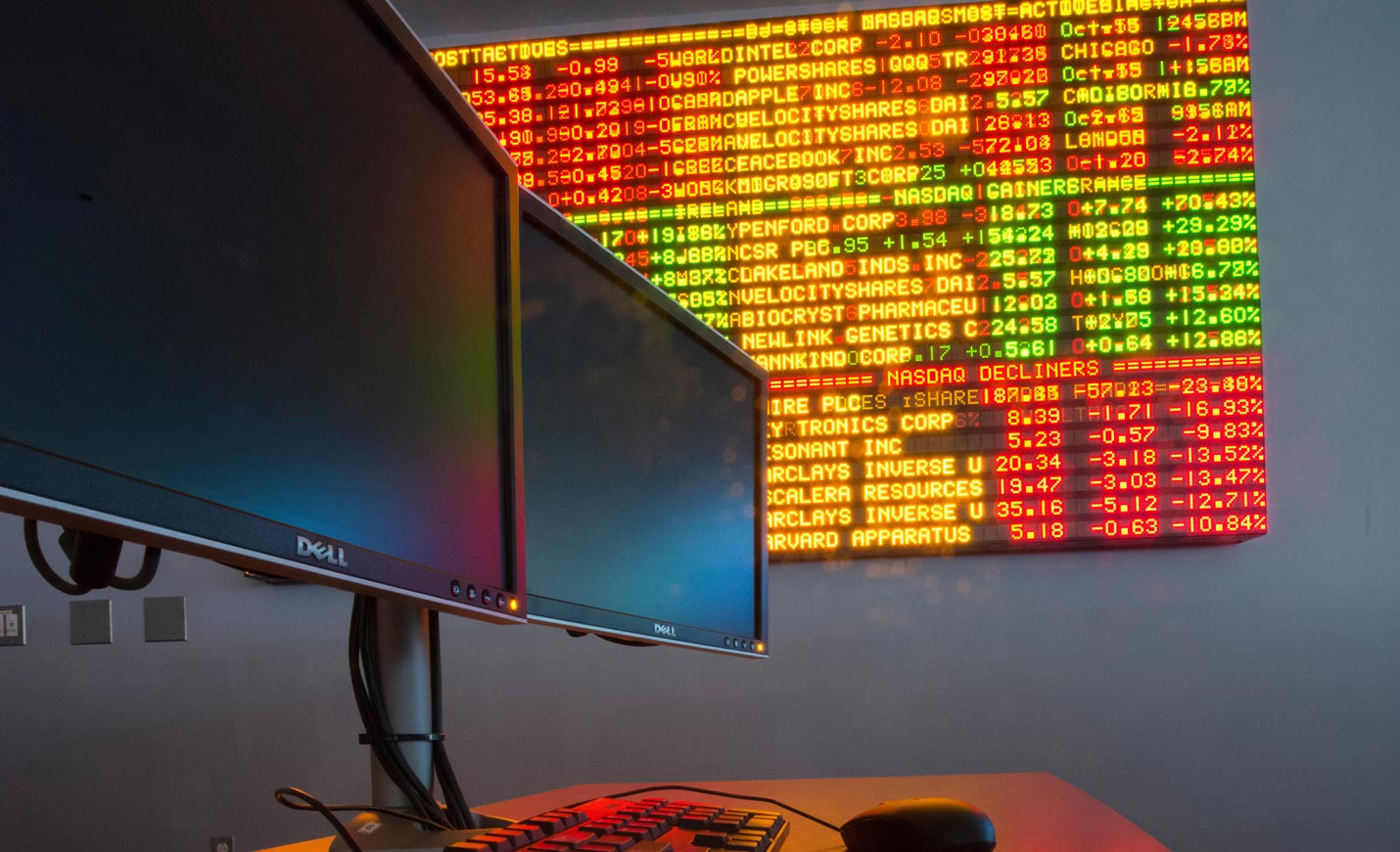 Computers in front of the stocks ticker in Congdon Hall