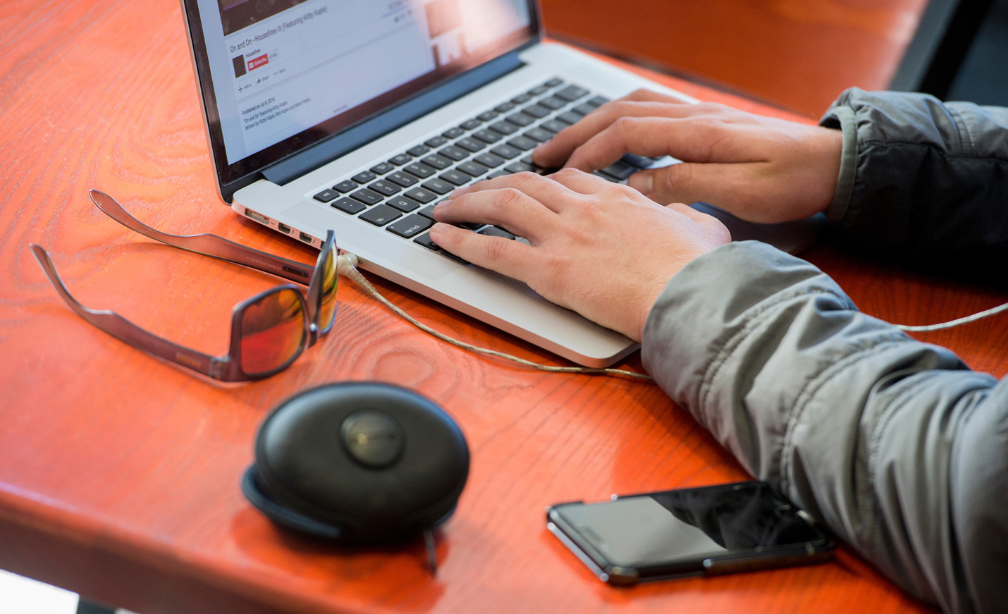 Student typing on a laptop