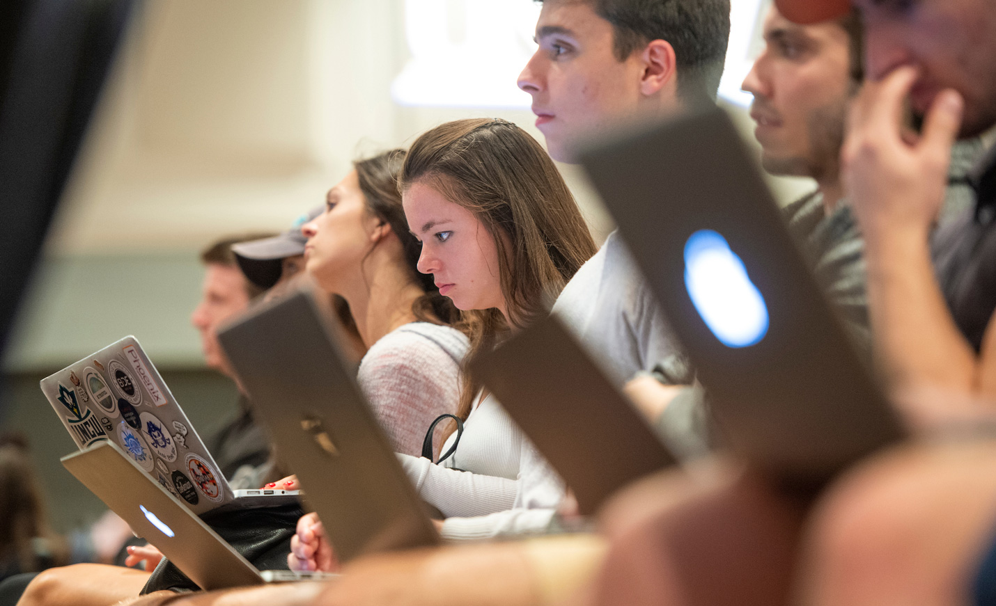 students at a lecture with their laptops