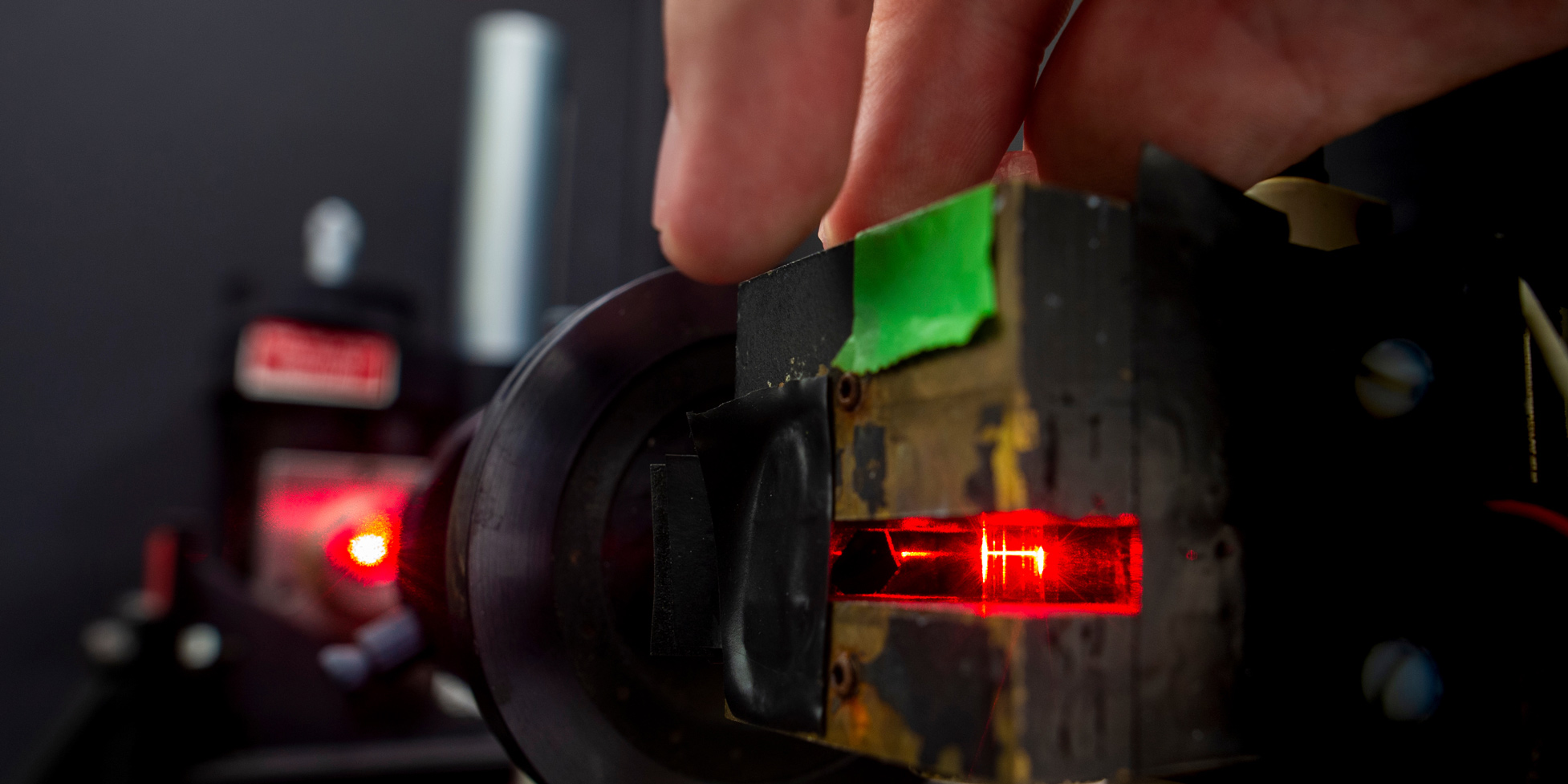 A close-up of a person working with a laser 