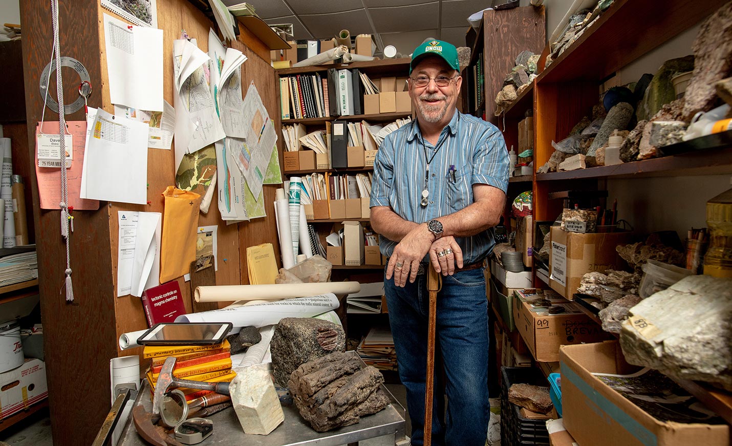 Professor in room with rocks
