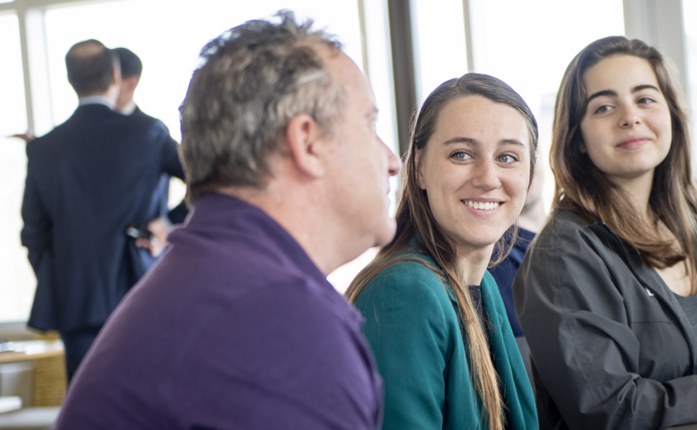 Three educators sitting at a table smiling