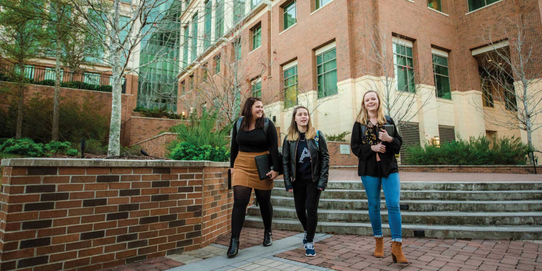 three students walking outdoors