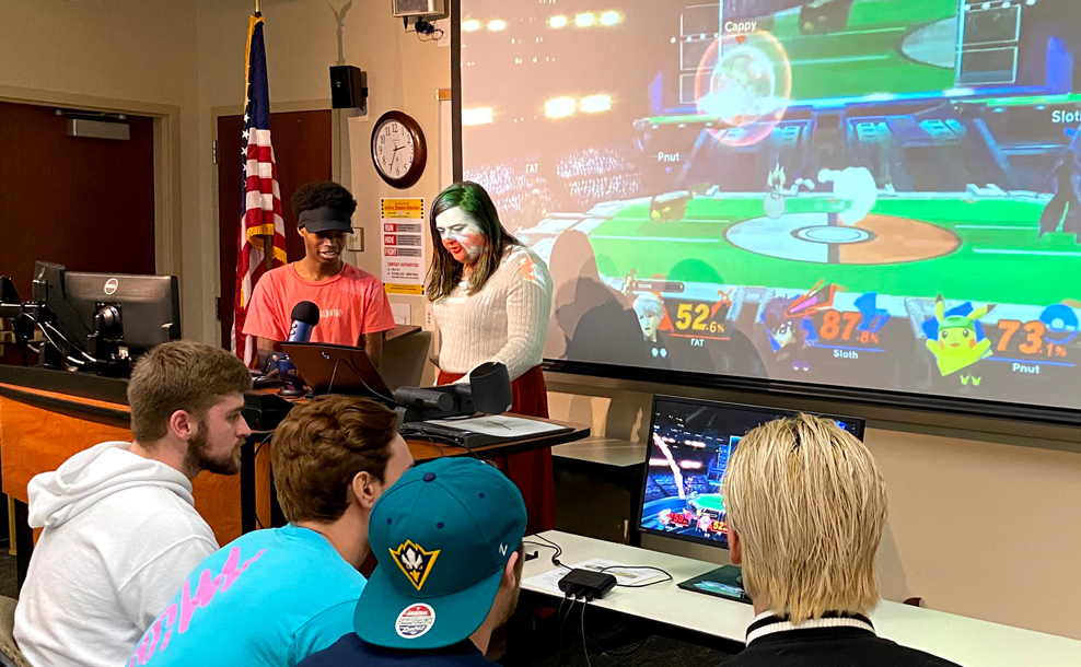 Students playing a video game on a projector screen