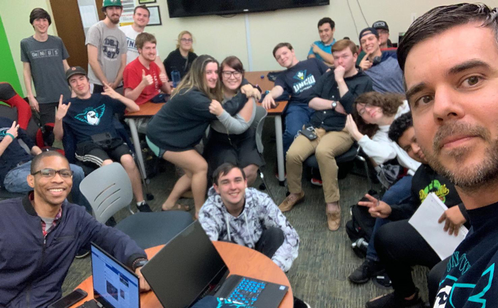 Dr. Pastore taking a selfie with students in the background