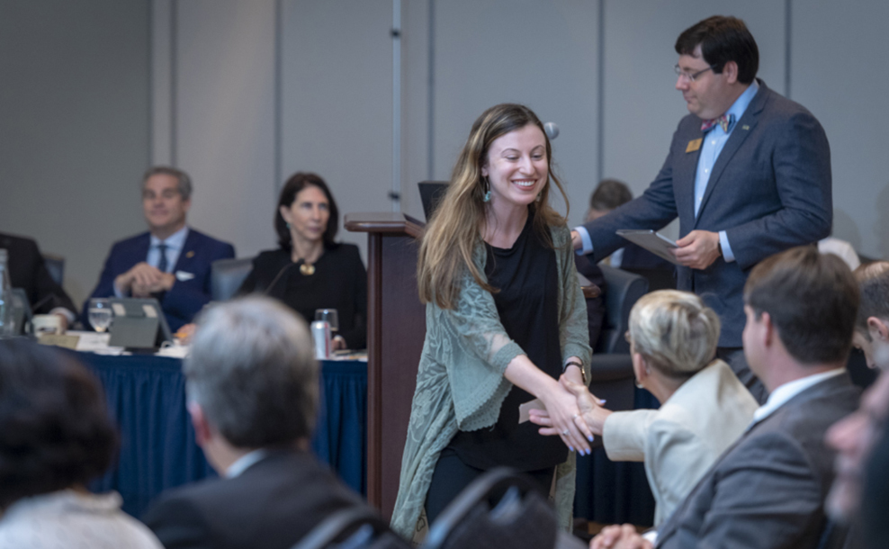 Student shaking hands after recieving an award