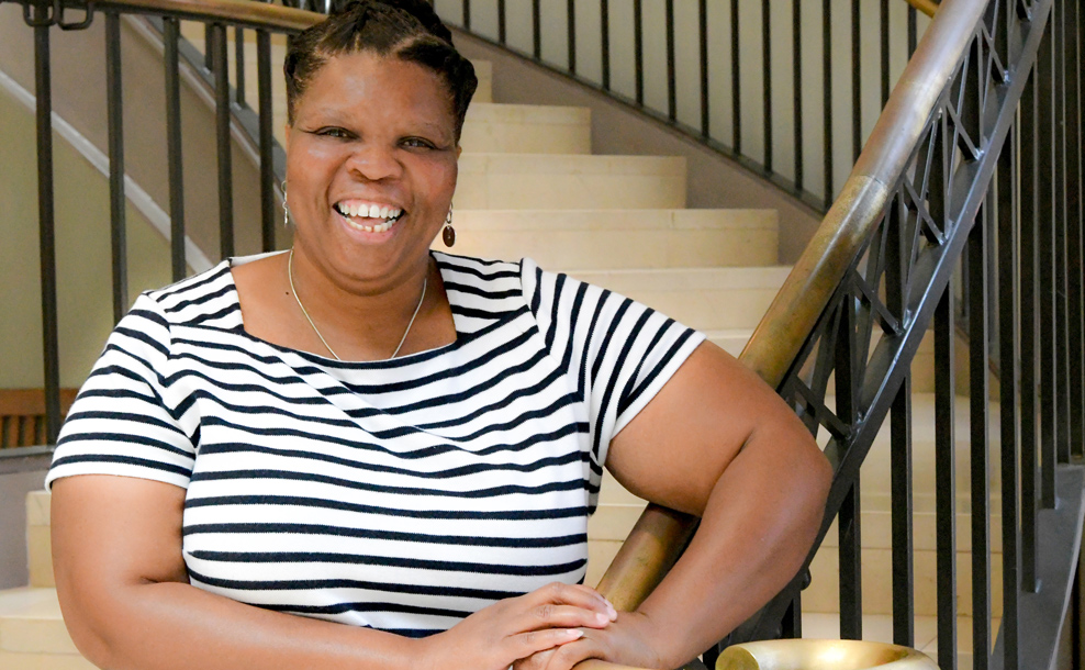 Portrait of Dr. Regina Wooten leaning on a stair railing