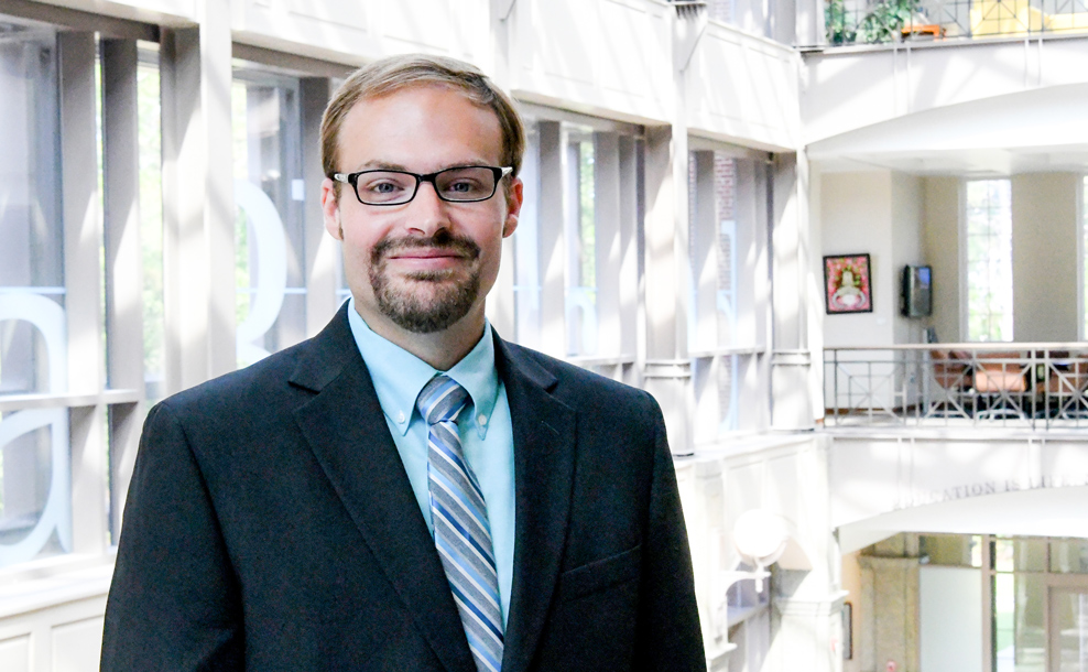 Portrait of Dr. Brian Tunstall in a suit and tie