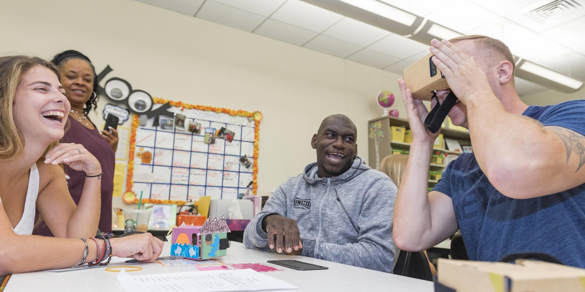 Group of Watson students looking through a VR headset