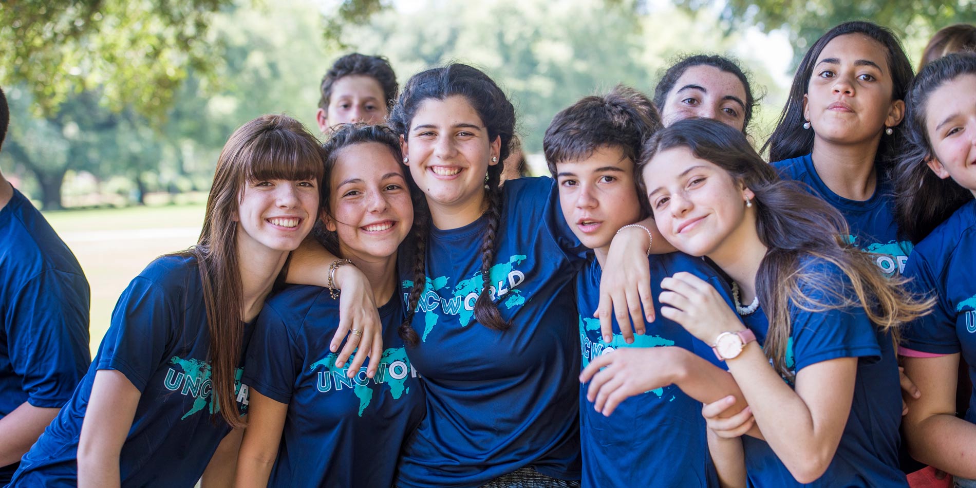 Group of kids wearing UNCW shirts